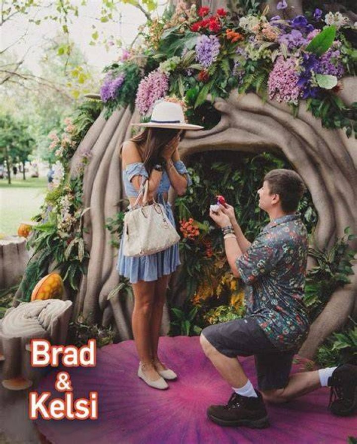 Brad and Kelsi posing at Pokémon GO Fest with her engagement ring